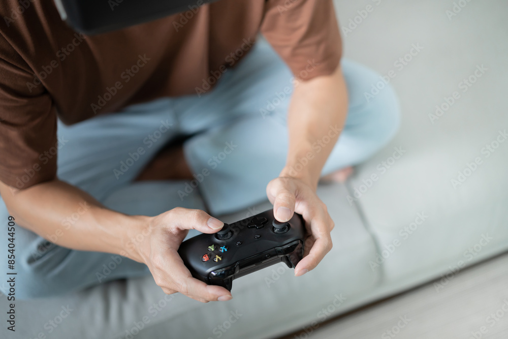 Young Asian man gamer controller video console playing holding hobby playful Online Video Game enjoyment eSport Cyber Games Internet. Young Asian man gamer controller video console playing holding hobby playful Online Video Game enjoyment eSport Cyber Games Internet.