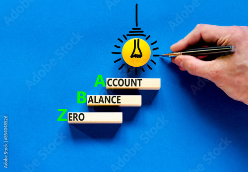 ZBA zero balance account symbol. Concept words ZBA zero balance account on beautiful wooden blocks. Businessman hand. Beautiful blue background. Business ZBA zero balance account concept. Copy space. photo