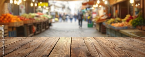 Empty wooden table with a blurred background of a bustling market street filled with colorful fruits and vegetables, perfect for mockups.