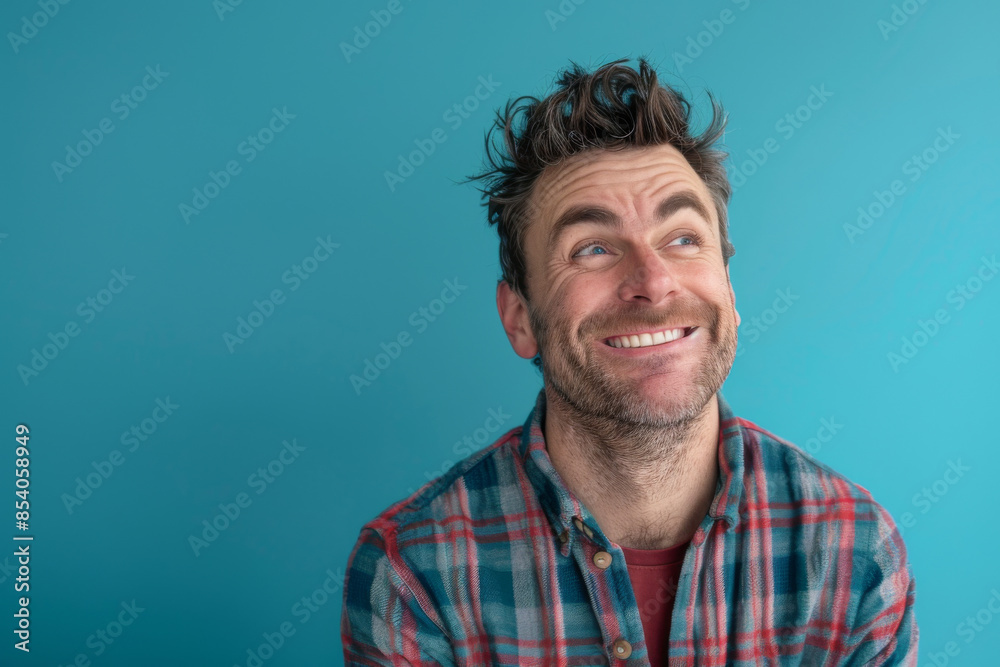 Obraz premium a Caucasian man expressing contentment on a blue studio background