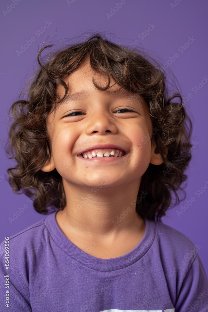 a Hispanic child feeling amused on a purple studio background a Hispanic child feeling amused on a purple studio background