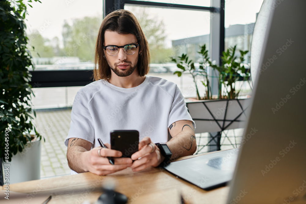A Caucasian businessman working diligently while using a smartphone at his desk. A Caucasian businessman working diligently while using a smartphone at his desk.