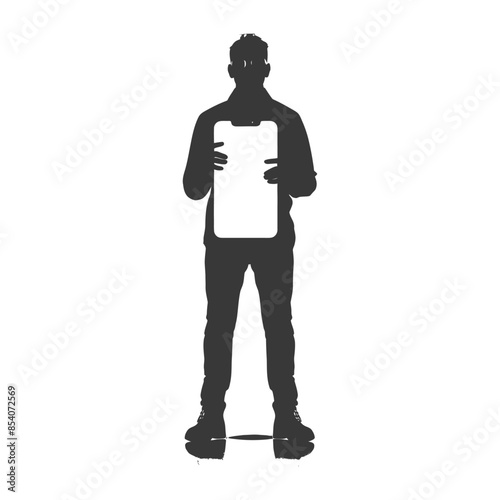 Silhouette of a man holding a brightly illuminated tablet, isolated.