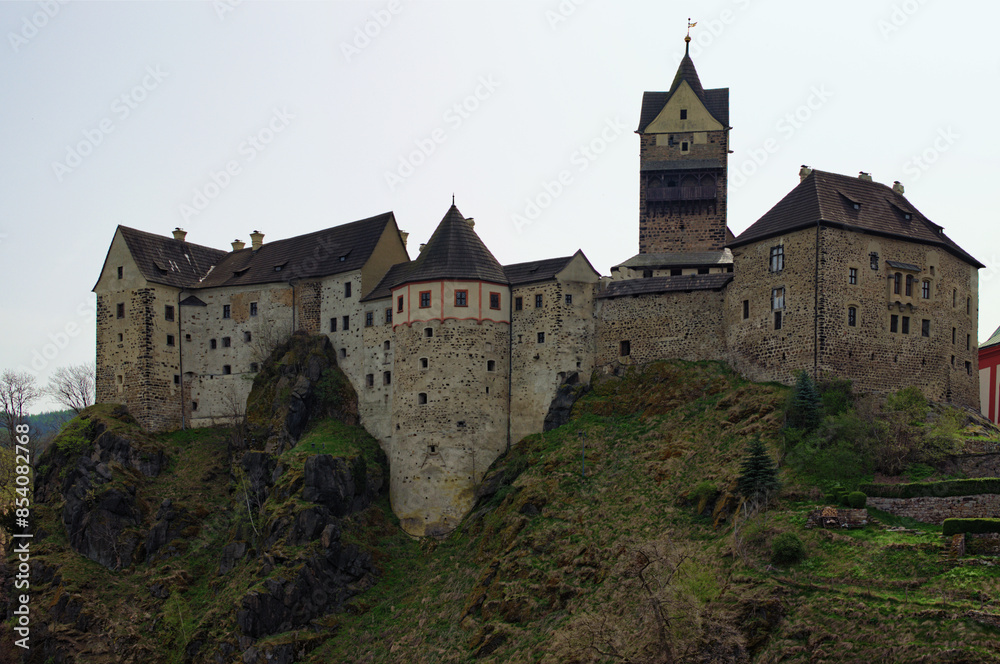 Scenic landscape view medieval castle on the top of the hill. Loket Castle, Karlovy Vary region. Famous touristic place and romantic travel destination in the Czech Republic.UNESCO World Heritage Site Scenic landscape view medieval castle on the top of the hill. Loket Castle, Karlovy Vary region. Famous touristic place and romantic travel destination in the Czech Republic.UNESCO World Heritage Site