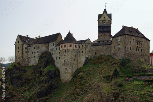 Scenic landscape view medieval castle on the top of the hill. Loket Castle, Karlovy Vary region. Famous touristic place and romantic travel destination in the Czech Republic.UNESCO World Heritage Site