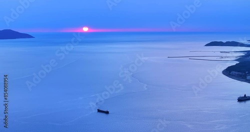 A sunset over the Ionian sea in Vlore, southern Albania showing Sazani Island on the Horizon.  photo