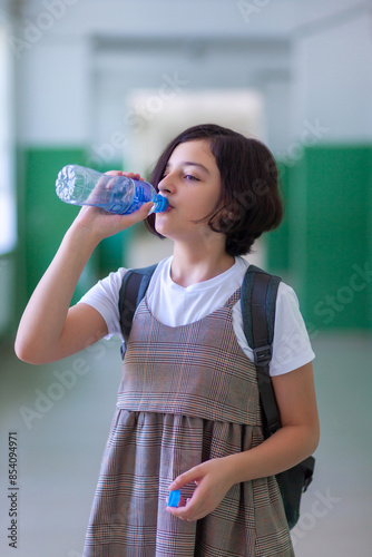 Beautiful girl in a school corridor posing for the camera