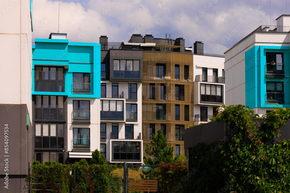 Fototapeta premium City view on a sunny day. Modern houses against the blue sky.