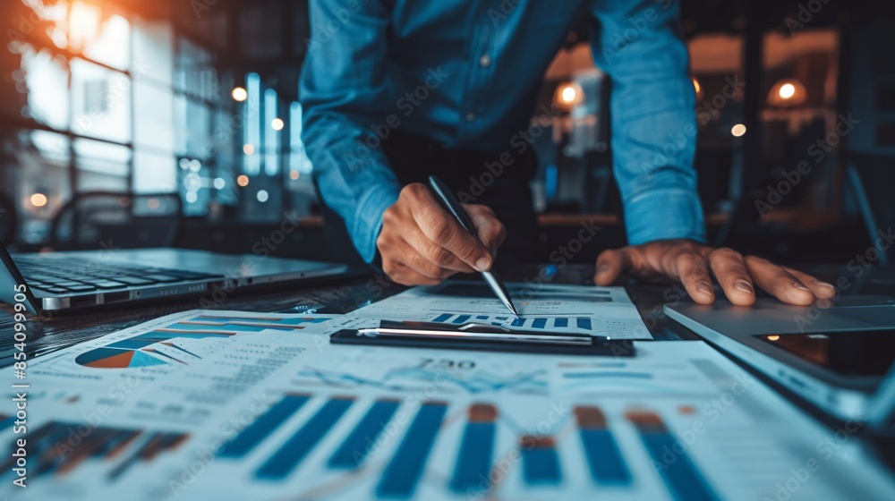 A Financial Expert Analyzing Business Reports and Financial Charts in a Modern Corporate Office A Financial Expert Analyzing Business Reports and Financial Charts in a Modern Corporate Office