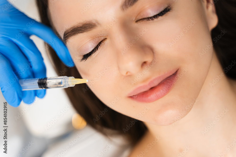 Cosmetology injections for getting rid of wrinkles. Young caucasian girl improves skin condition in cosmetology clinic. Cosmetology injections for getting rid of wrinkles. Young caucasian girl improves skin condition in cosmetology clinic.