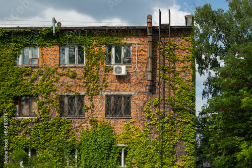 Photos An old red brick building overgrown with ivy