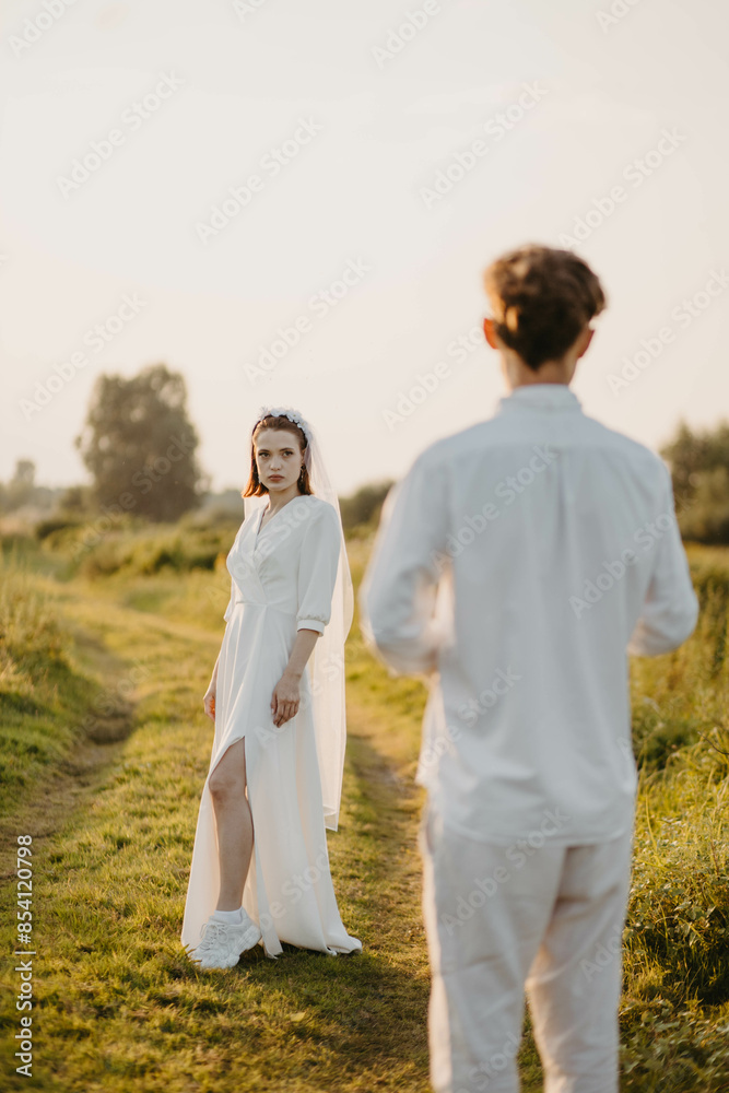 newlywed couple in love in a field in nature at sunset in summer newlywed couple in love in a field in nature at sunset in summer