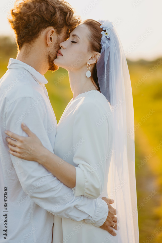 newlywed couple in love in a field in nature at sunset in summer newlywed couple in love in a field in nature at sunset in summer