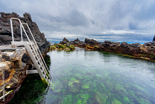 Area of natural pools with color contrasts in the parish of Saoo Roque on the island of Pico in the Azores archipelago. photo