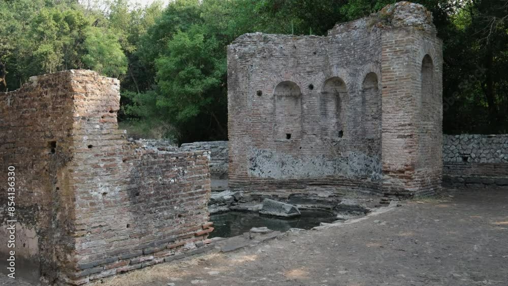 Restored old castle in Butrint in Albania. Aerial view of ruins of fortress in forest. Butrint Archaeological Park. Drone video. Butrint Albania