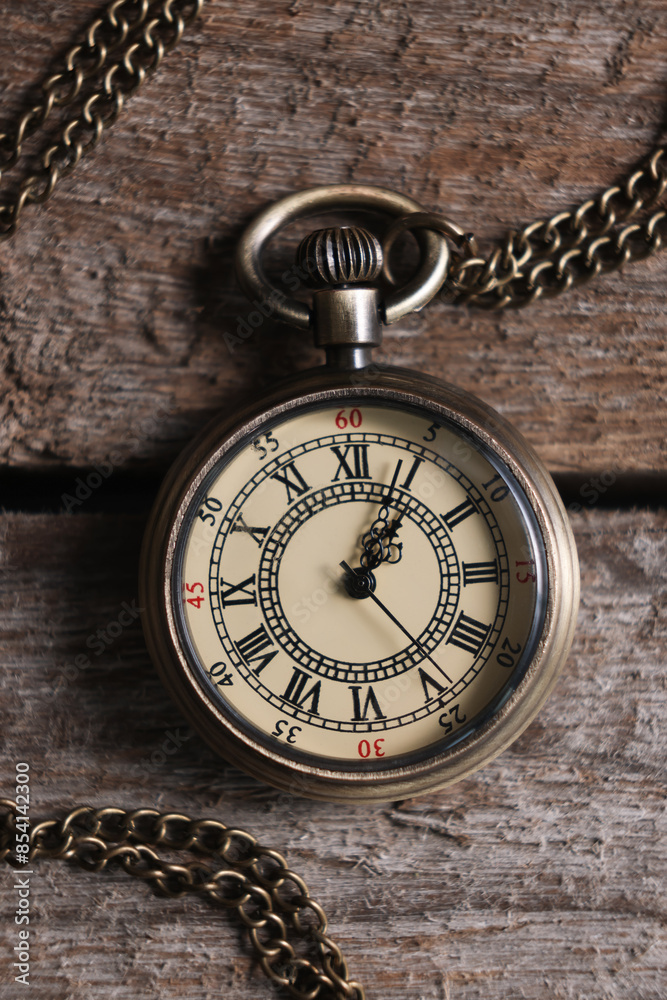 Pocket clock with chain on wooden table, top view Pocket clock with chain on wooden table, top view