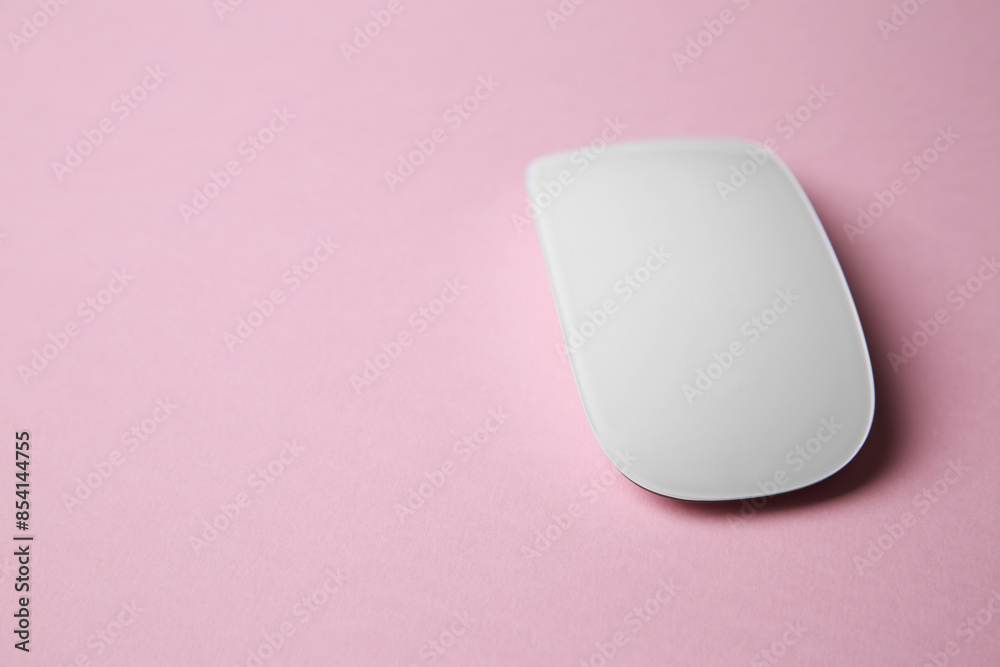 One wireless mouse on pink background. Space for text One wireless mouse on pink background. Space for text