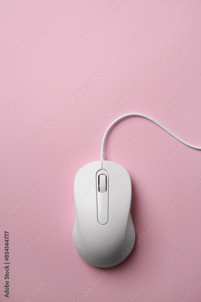One wired mouse on pink background, top view One wired mouse on pink background, top view