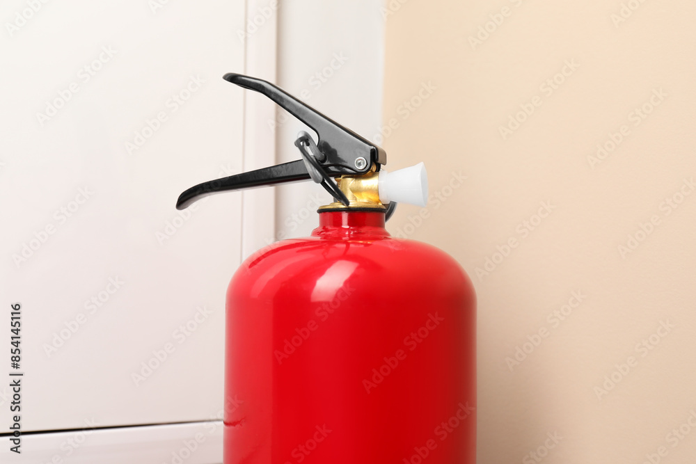 Obraz premium One fire extinguisher indoors, closeup. Safety equipment