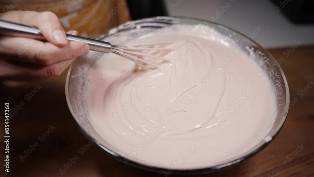 A Woman Stirs Pink Cream Or Milk With A Metal Whisk. A Woman Stirs Pink Cream Or Milk With A Metal Whisk.