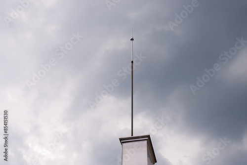 Lightning rod on a roof in a rainy day photo