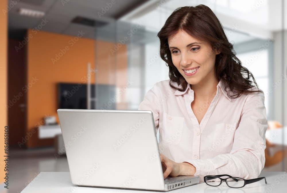 Happy smiling professional businesswoman investor work on laptop Happy smiling professional businesswoman investor work on laptop
