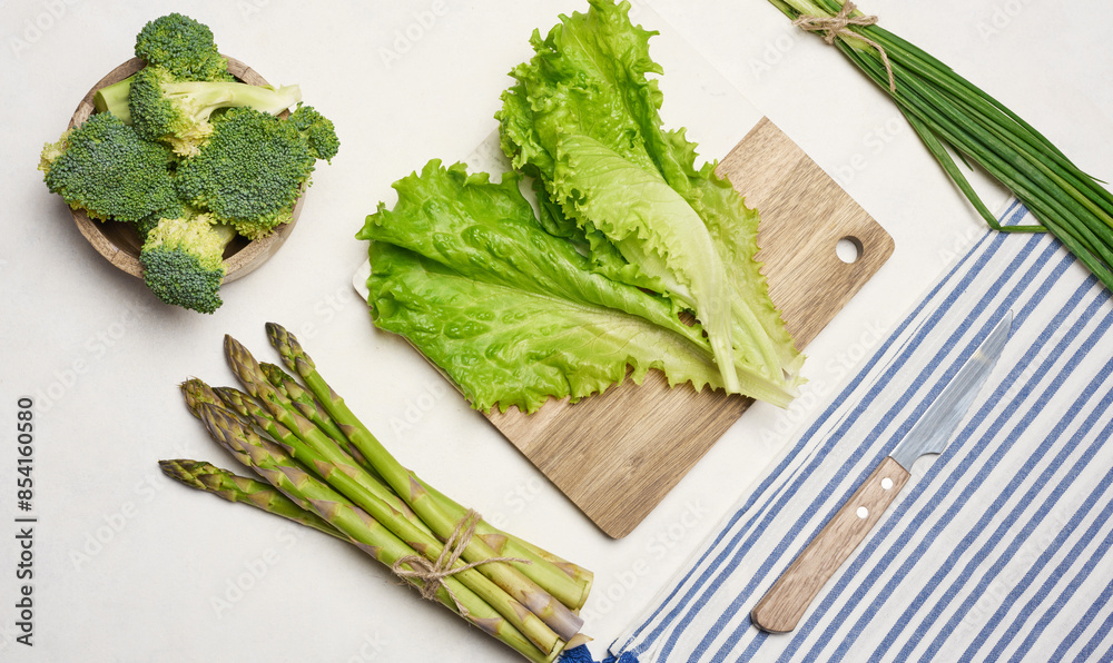 Raw asparagus, broccoli and spices on white background Raw asparagus, broccoli and spices on white background