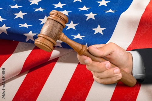 Judge's wooden gavel and USA flag photo