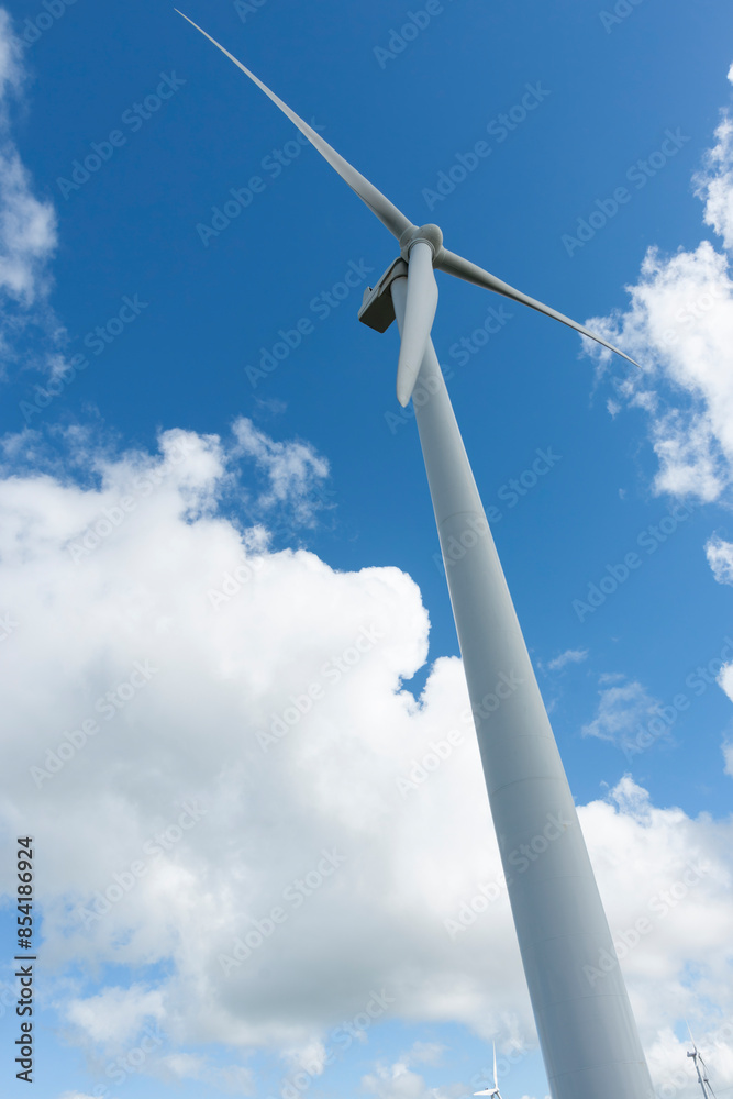 Wind turbine under cloudy sky from low angle point of view. Wind turbine under cloudy sky from low angle point of view.