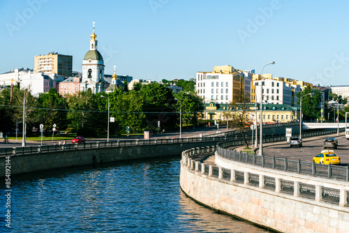 Moscow, Russia - May 23, 2024: Kotelnicheskaya Embankment, Moskva River, view of the river and the church from the bridge. Selected focus. High quality photo photo