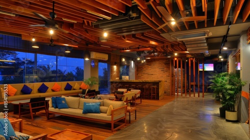 Contemporary lounge area with stylish wooden decor, comfortable seating, and warmly lit ambiance featuring an open bar and large windows