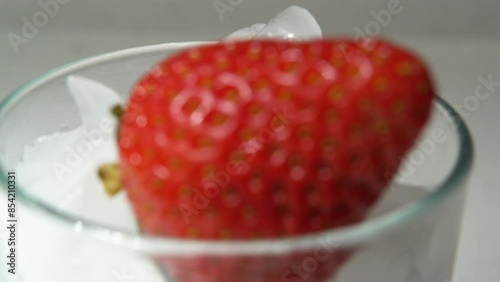 dolly shot of a strawberries in a glass full of ice