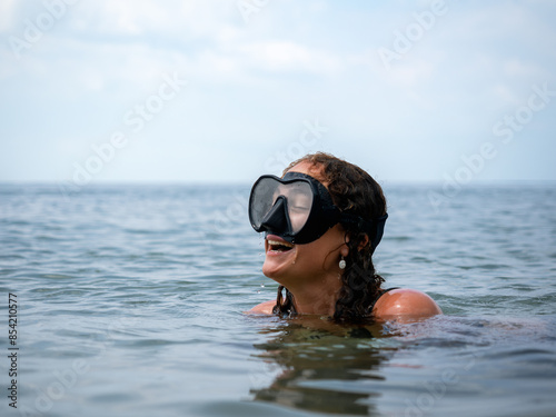 Woman Laughing While Snorkeling in Clear Ocean © DayfaPhoto
