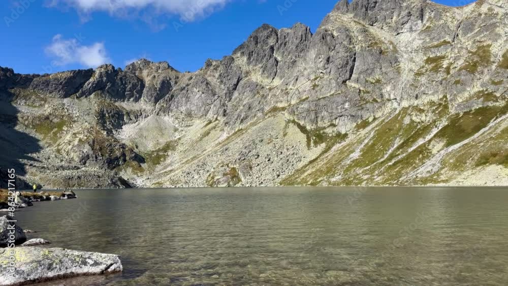 A mountain range with a lake in the foreground, Slovakia A mountain range with a lake in the foreground, Slovakia