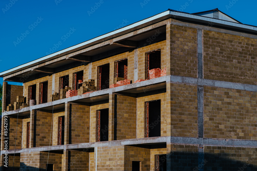 Construction of three-storey building in summer Construction of three-storey building in summer