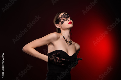 Photo of lady in black mask costume touch chest close eyes feel tempting isolated red color background