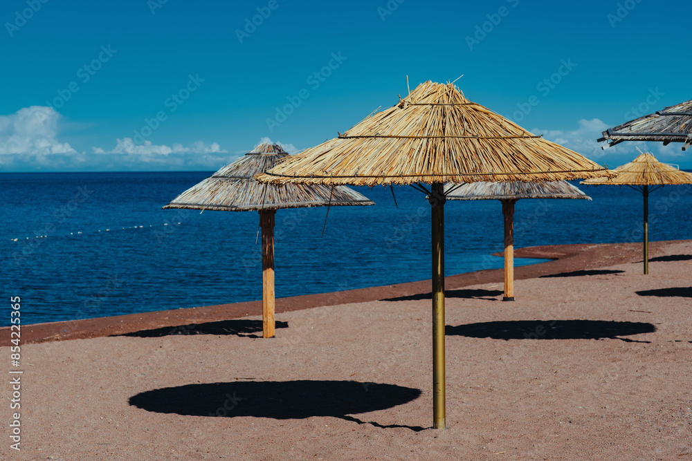 Fototapeta premium Umbrellas on sea beach on summer day