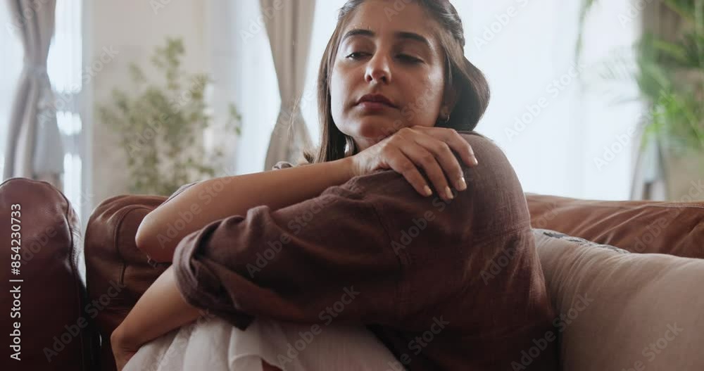Anxiety, depression and sad woman thinking on sofa with stress, risk or mistake at home. Conflict, fear and girl remember ptsd memory, trauma or domestic violence, crisis or mental health disaster