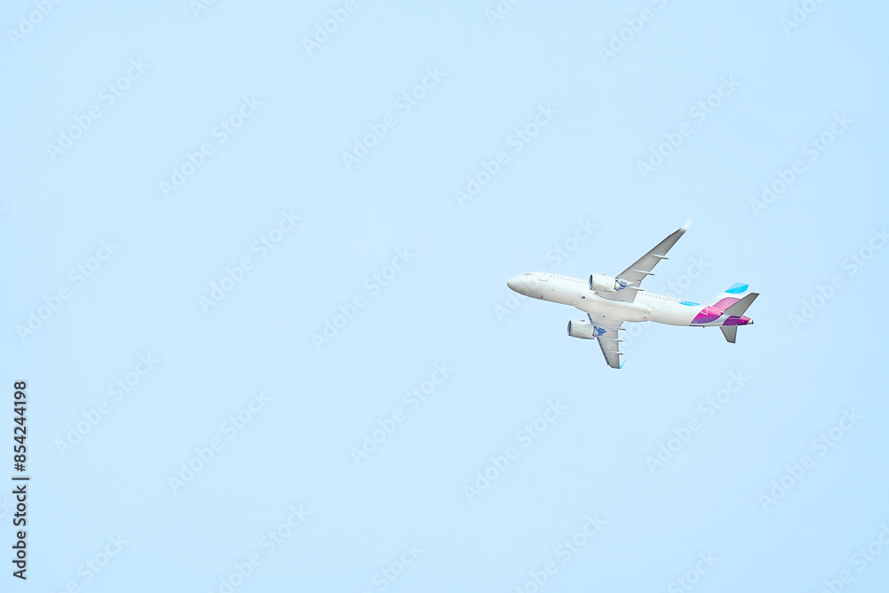 High flying airplane in blue sky. View from below High flying airplane in blue sky. View from below