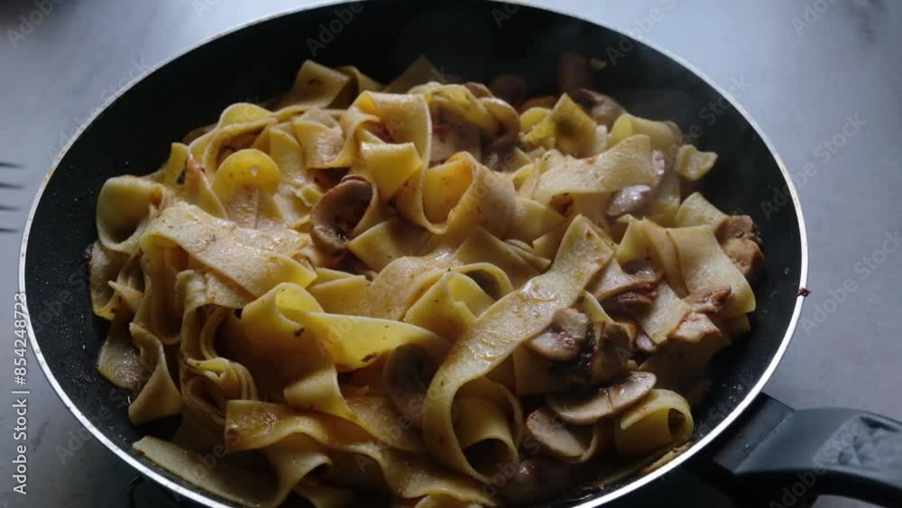 cooking pasta in a Fettucini Alfredo cooking pasta in a Fettucini Alfredo