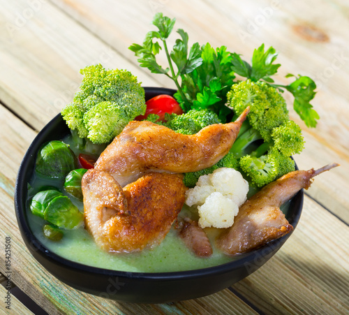 Cream soup boiled with quail, served with broccoli, brussels sprouts and cauliflower photo