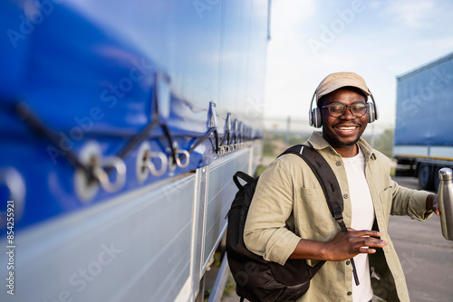 Cheerful truck driver dancing while coming to work.