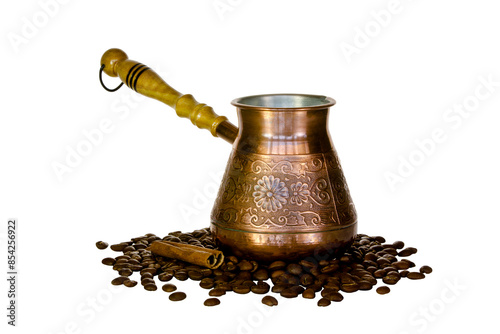Copper coffee pot and scattered coffee beans.