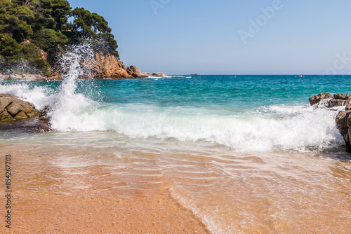 beach in Cala Sa Boadella Bay, Costa Brava, Lloret de Mar, Catalonia, Spain. Beautiful seascape. huge waves photo