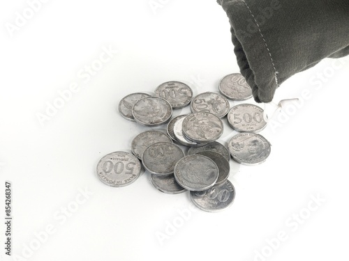 500 rupiah coins. Rupiah coins. taken out of a small bag. Stack of Indonesian Rupiah silver coins.