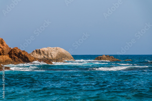 beach in Cala Sa Boadella Bay, Costa Brava, Lloret de Mar, Catalonia, Spain. Beautiful seascape. huge waves photo