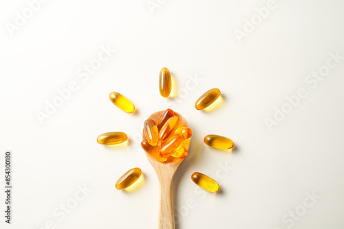 wooden spoon with soft gels, Fish oil capsules, omega 3, omega 9, vitamin D, vitamin E