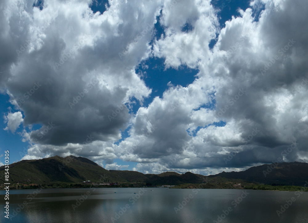 Panorama view of the reservoir Potrero de los Funes in San Luis, Argentina. The green forest, hills and lake under a dramatic sky with beautiful clouds. Panorama view of the reservoir Potrero de los Funes in San Luis, Argentina. The green forest, hills and lake under a dramatic sky with beautiful clouds.