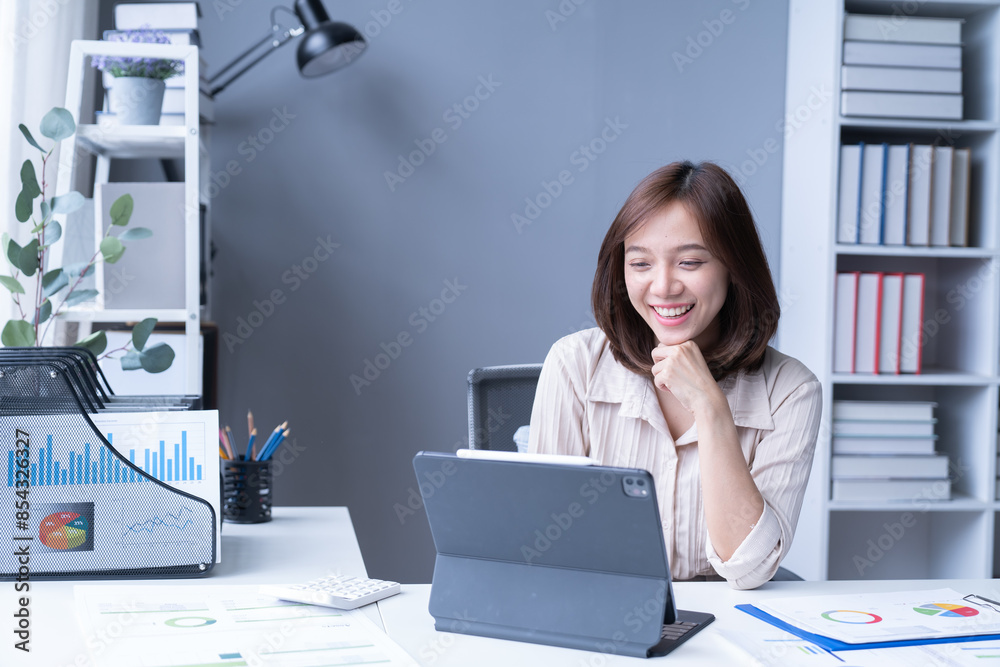 A professional headshot of a female executive, seated at her desk and exuding contentment in her corporate environment. A professional headshot of a female executive, seated at her desk and exuding contentment in her corporate environment.