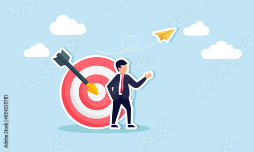 Business aims set goals, resolutions, aspire, and strive for success with motivation, concept of A confident businessman stands as his arrow hits the bullseye on an archery target